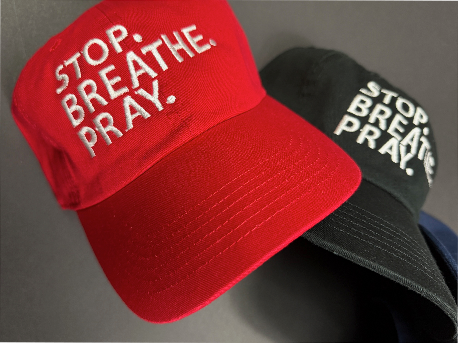 "Unstructured dad hat in red, navy blue, or black with white embroidered 'Stop. Breathe. Pray.' slogan – faith-based streetwear cap, Christian inspirational hat, breathable low-profile baseball cap for men and women"